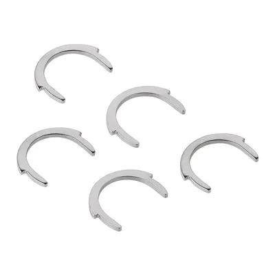A group of five silver-colored metal rings with a C-shape and notches on a white background.