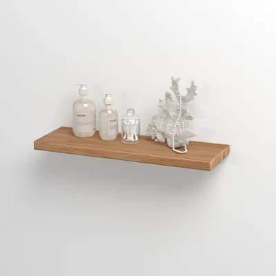 A wooden shelf mounted on a white wall, displaying two soap dispensers, a glass jar with cotton swabs, and a decorative coral piece with beads.