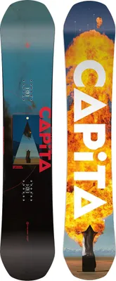 Two snowboards are shown side-by-side, one with a blue and black design featuring a geometric image, and the other with a vibrant orange and yellow explosion graphic.