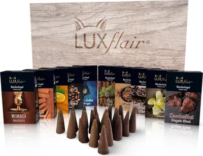 A collection of incense cones and their packaging, displayed in front of a wooden box.