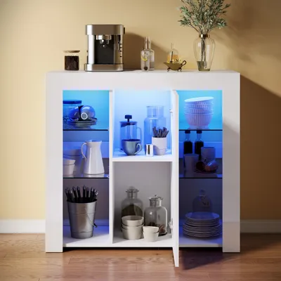 A white high-gloss sideboard with glass shelves illuminated by blue LED lights, displaying various kitchenware and decorative items.