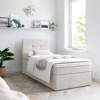 A bedroom scene with a bed, shelf, and plant.