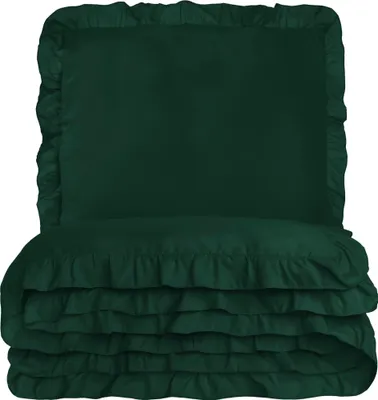 A stack of dark green bedding with ruffles.