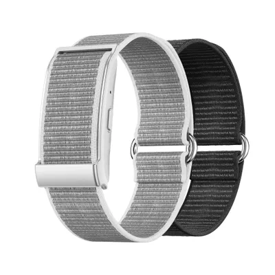 Two fitness bands, one silver and one black, are shown side-by-side against a white background.