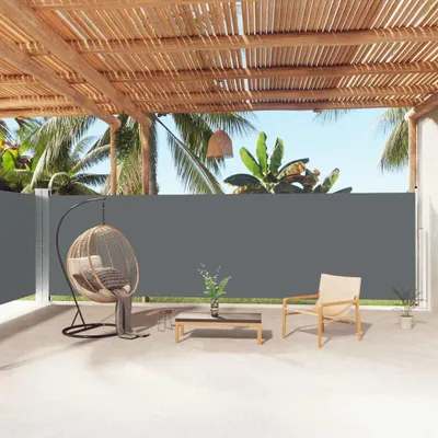 An outdoor patio area with furniture and a retractable side awning.
