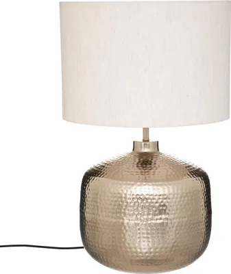 A table lamp with a beige lampshade and a hammered metallic base.