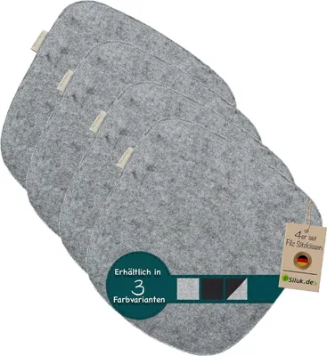A set of four grey felt seat cushions arranged in a stack, with a white background.