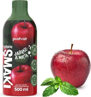 A bottle of apple and mint flavored syrup next to a fresh apple and mint leaves.