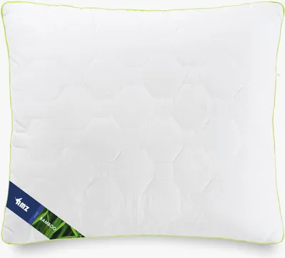 A white quilted pillow with a green trim and a label indicating it is made of bamboo.
