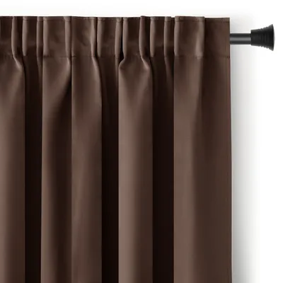 A close-up view of a brown curtain hanging from a curtain rod.