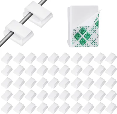 A collection of white cable clips and a stack of adhesive pads.