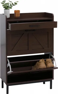 A dark brown shoe cabinet with a drawer and two flip-out compartments, shown against a white background. A small plant and a candle are on the top shelf.