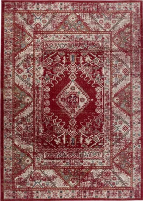 A flat lay of a rectangular rug with a classic, distressed design.