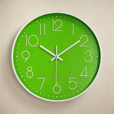 A green wall clock with white numbers and hands is shown against a textured light beige wall.
