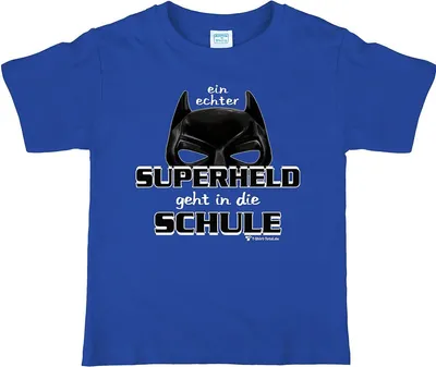 Blaues Kinder T-Shirt mit Superhelden-Maske und Aufdruck „Ein echter Superheld geht in die Schule“ auf weißem Hintergrund.