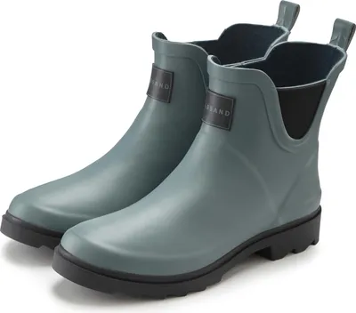 A pair of green ankle boots on a white background.