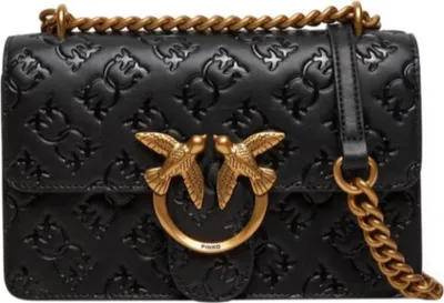 A black leather handbag with gold hardware and a chain strap.