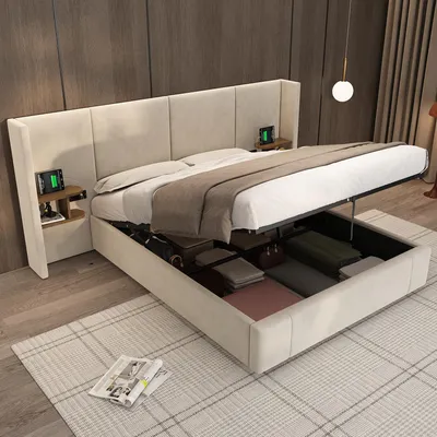 A modern bedroom with a beige upholstered storage bed, open to reveal storage compartments. Two bedside tables with charging devices are attached to the headboard.
