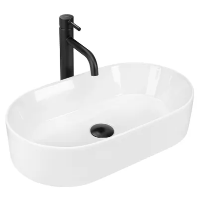A white oval countertop sink with a black faucet and drain.
