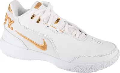 A white Nike basketball shoe with gold accents, shown from the side.
