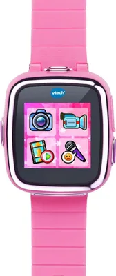 A pink VTech Kidizoom Smart Watch DX7 is shown from the front against a white background. The watch face displays four colorful icons: a camera, a video camera, a film strip with a play button, and a microphone with a smiley face.