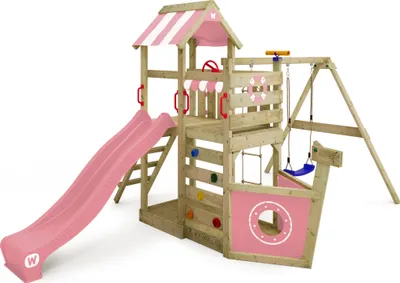 A wooden playground set with a pink and white striped roof, a pink slide, a climbing wall with colorful holds, a swing, and a ship-like front section.