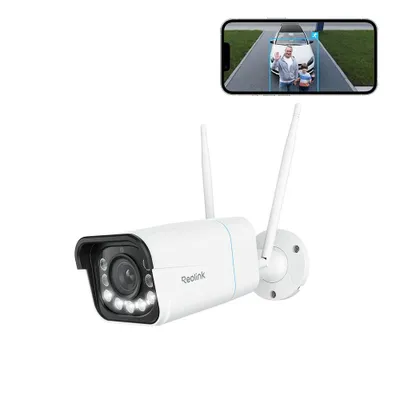A white Reolink security camera with two antennas is shown in the foreground, with a smartphone displaying a live feed from the camera in the background.