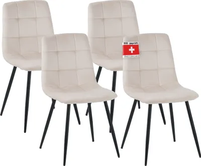 Four beige upholstered dining chairs with black metal legs are arranged in a cluster.