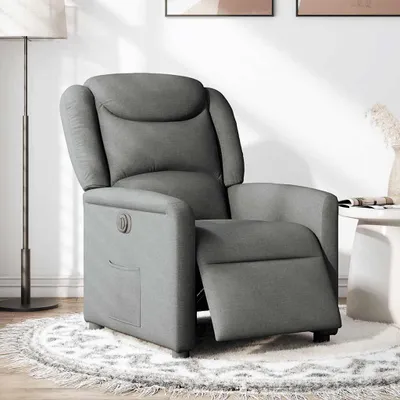 A gray fabric recliner chair is shown in a room with a lamp and a side table.