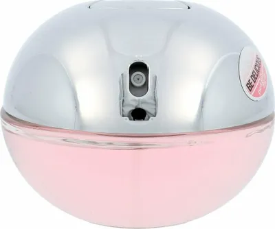 A close-up, front-facing view of a spherical pink and silver perfume bottle.