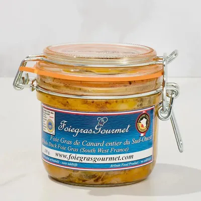 A glass jar of foie gras with a label.