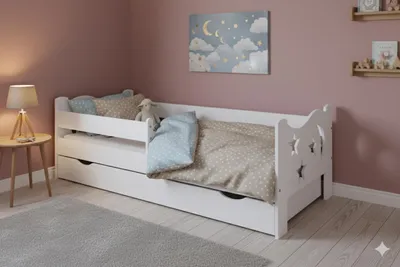 A child's bedroom with a white bed, bedding, and a bedside table with a lamp.