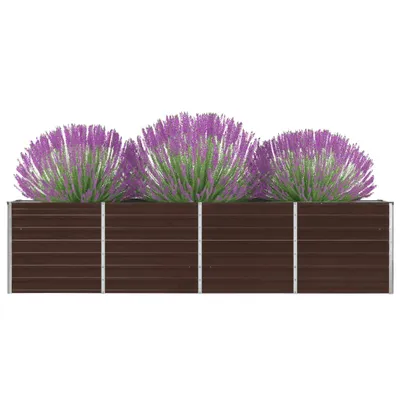 A raised garden bed with three purple flowering plants.