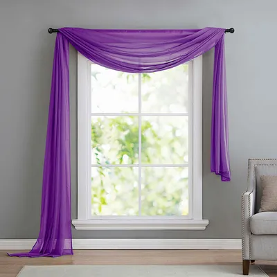 A purple sheer scarf draped over a window.