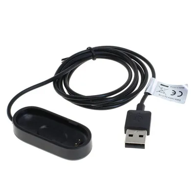 A black USB charging cable and adapter for a fitness tracker.