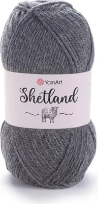A ball of grey yarn with a label wrapped around it.