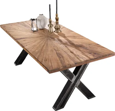 A rectangular wooden dining table with an X-shaped metal base, shown from a diagonal angle.