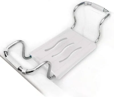 A white bath seat with silver metal supports is placed across a white bathtub.