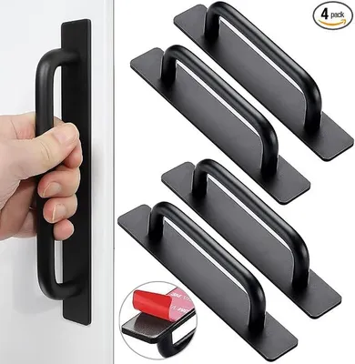 A hand is shown pulling a black cabinet handle attached to a white surface, while a pack of four similar handles is displayed on the right side of the image.