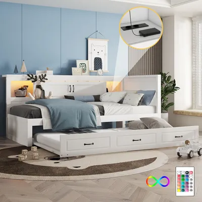 A white daybed with a trundle bed pulled out, set in a child's bedroom with blue walls and a rug.