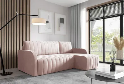 A modern living room with a pink sectional sofa, a floor lamp, and a large window overlooking greenery.