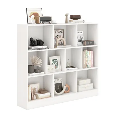 A white bookshelf filled with various decorative items and books.