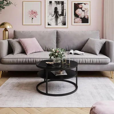 A living room scene with a sofa, coffee table, and artwork.