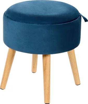 A blue velvet ottoman with wooden legs is shown against a white background.