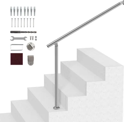A handrail system installed on a set of stairs, with installation accessories laid out to the side.