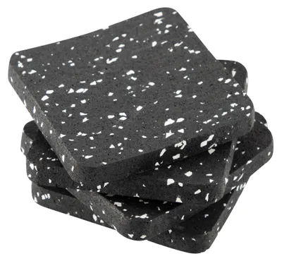 A stack of four black vibration dampening pads with white speckles.