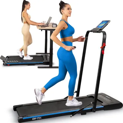 Two women are using treadmills in a studio setting. One woman is running on a treadmill in the foreground, while another woman is walking on a treadmill and working on a laptop at a standing desk in the background.