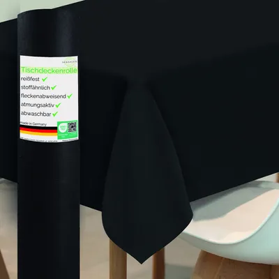 A roll of black tablecloth is shown next to a table covered with the same material.