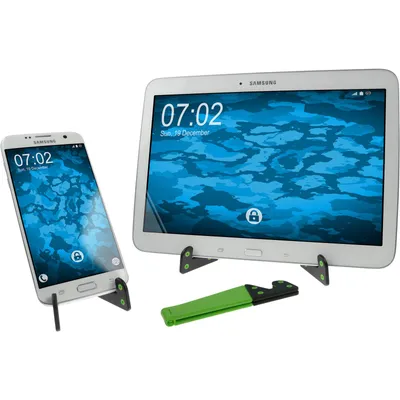 A smartphone and a tablet are displayed on stands, with a green accessory in the foreground.