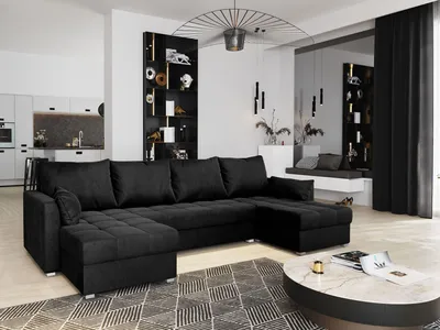 A modern living room with a large black sectional sofa and a marble coffee table.